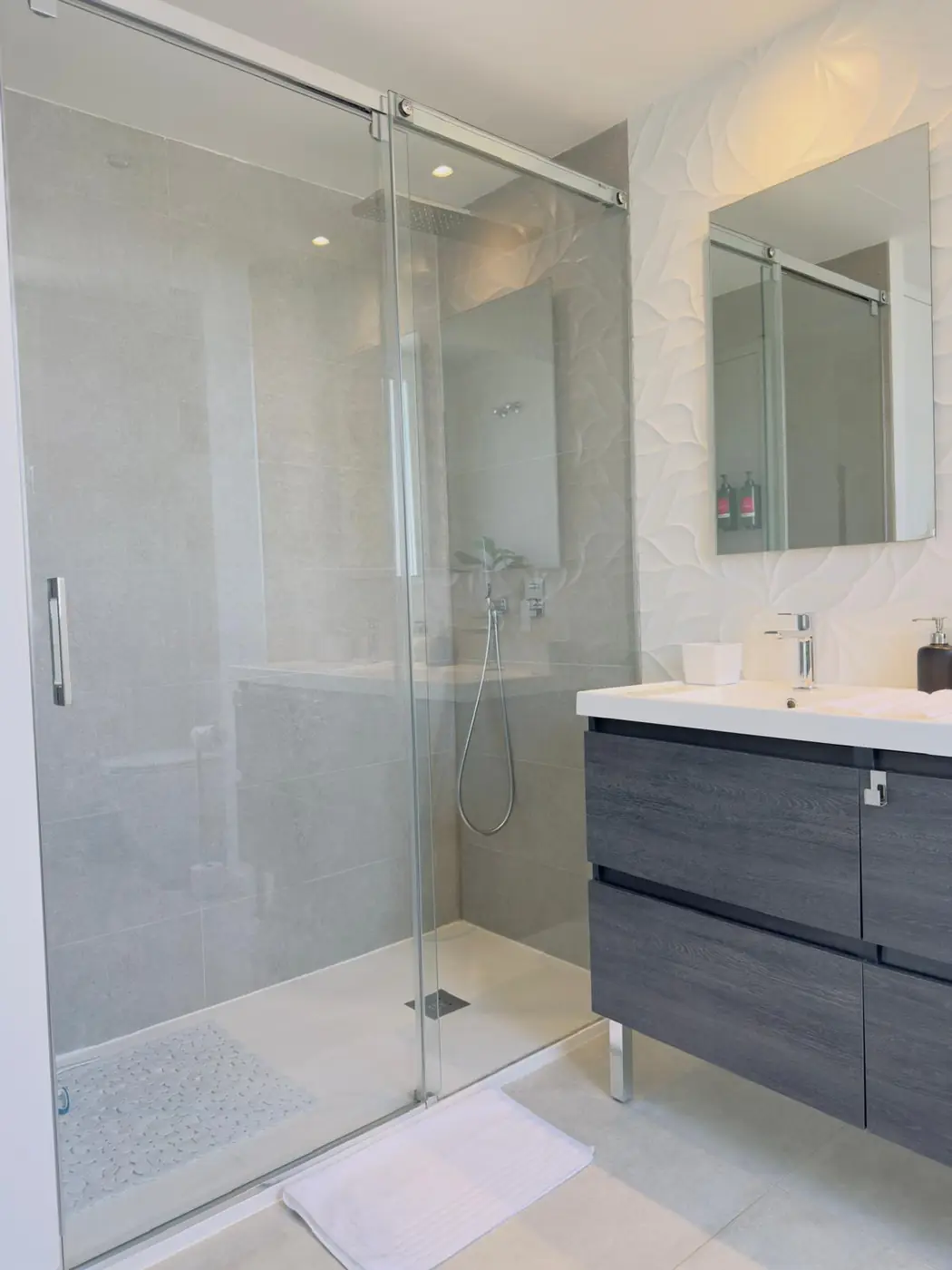 Bright clean bathroom with a glass shower screen